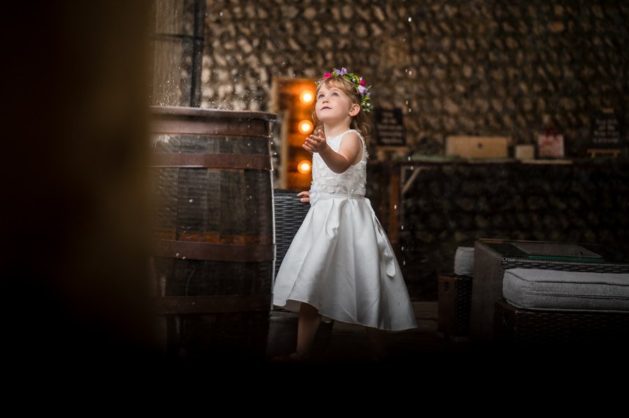 Flower girl playing with the rain drops